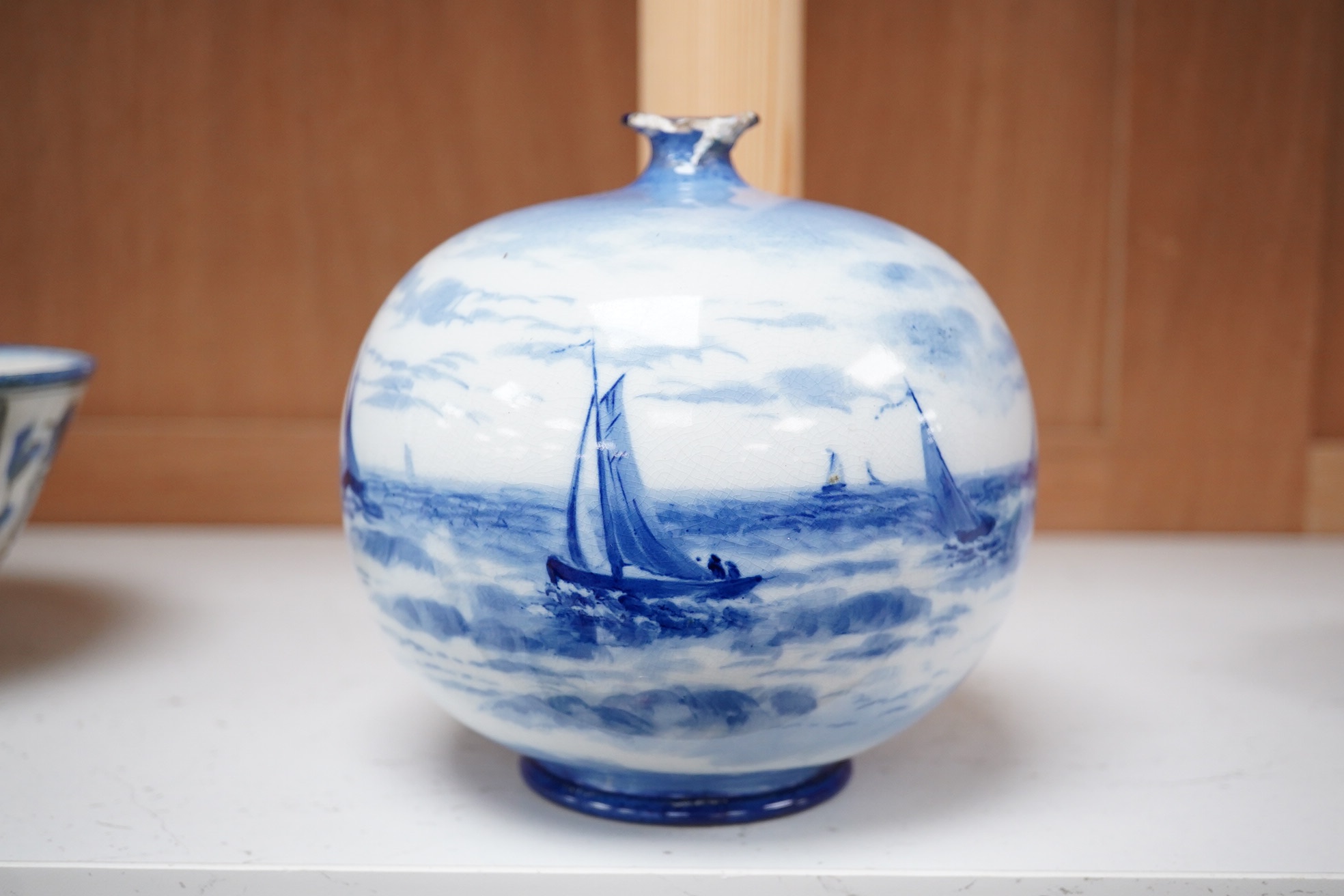 A Doulton Burslem Mount Edgecumbe, Plymouth blue and white signed vase, 14.5cm high. Condition - top rim broken